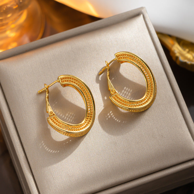 Titanium steel material twisted hollow gold-plated ear buckle simple cold wind fashion earrings personalized earrings earrings wholesale women